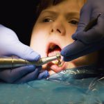 A girl undergoing treatment at the dentist's office