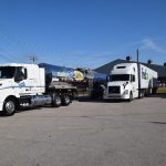 Three eighteen-wheeler trucks in parking lot