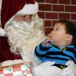 Child with autism sits on Santa's lap