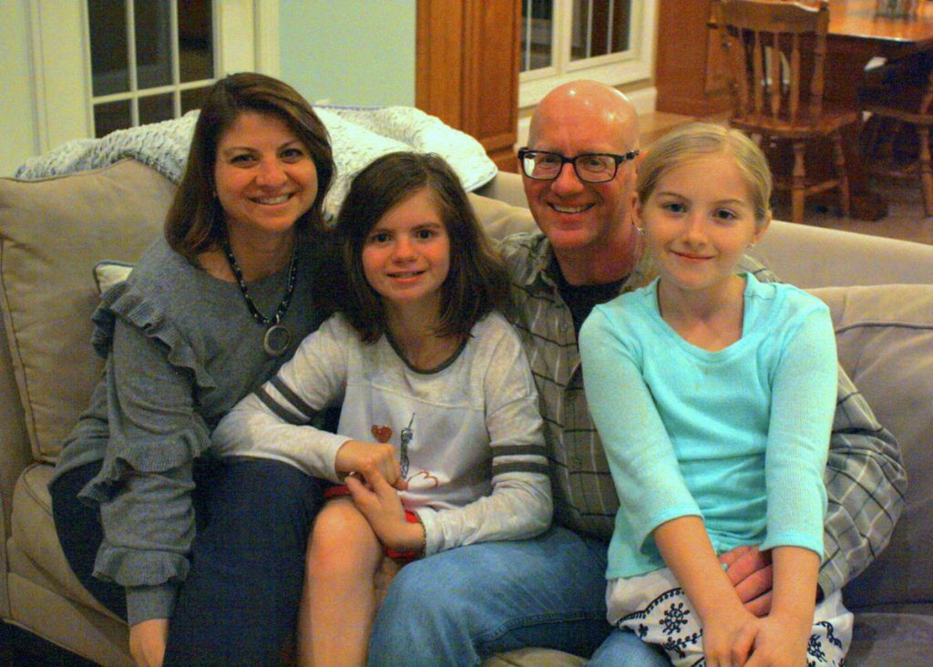 The Symons family pose for a photo in their Newark home.