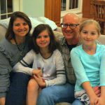 The Symons family pose for a photo in their Newark home.