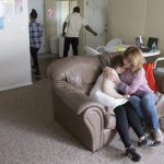 Mother comforts her daughter, who has autism