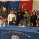 New Castle County Executive Matt Meyer, center, signs Ordinance 18-018 into effect