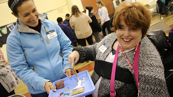 Volunteer Laura Cantagallo lends support to participant Linny Marbel at our 11th Artfest