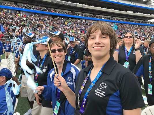 Special Olympics athlete Jillian Mathews waves a ribbon during the opening ceremony of the USA Games