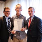 CDS Associate Director Brian Freedman, Cape Henlopen High School student Zach Simpler, and Gov. John Carney pose at bill signing