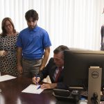 Governor John Carney signs HB 326 into law as advocates look on