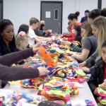 volunteers mismatch socks at a school cafeteria table