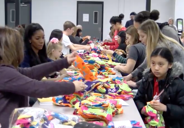 volunteers mismatch socks at a school cafeteria table