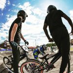 Three kids on bikes at a BMX park