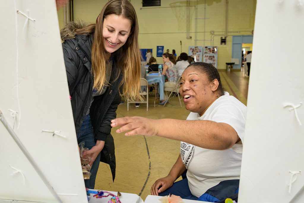 At Artfest 2018, UD student volunteer Chloe Weissman (left) and participant Ebony Tucker admire a finished project. (Evan Krape / University of Delaware)