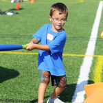 Young Special Olympian hits a ball during training