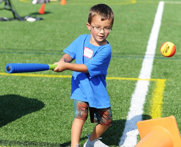 Young Special Olympian hits a ball during training