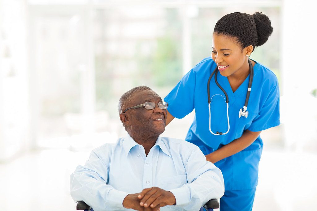 Nurse taking care of senior patient in wheelchair |