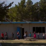 Students walking outside of their school in single file