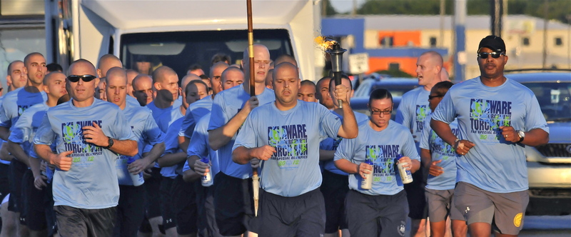 Mark W. Kristunas leads a group of police recruit runners as they accompany the torch