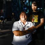 Retired Staff Sgt. Matt Lammers holds the hand of his wife, Alicia, before the swimming competition at the 2019 Department of Defense Warrior Games in Clearwater, Fla.