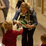 Parent Molly Myers works with kids to pass out door hangers at the Missouri Capitol while lobbying for legislation mandating that insurance cover therapy for children with developmental disabilities.