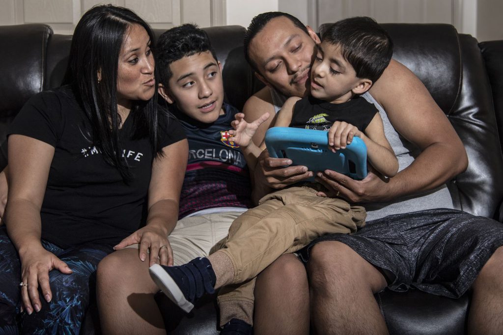 Velveth Roman Giron, left, and Pedro Marin Alvarez, with their children, Luis, 12, and Kevin, 5, at their home in Lancaster, Pennsylvania