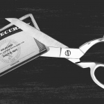 Social security card being cut with scissors
