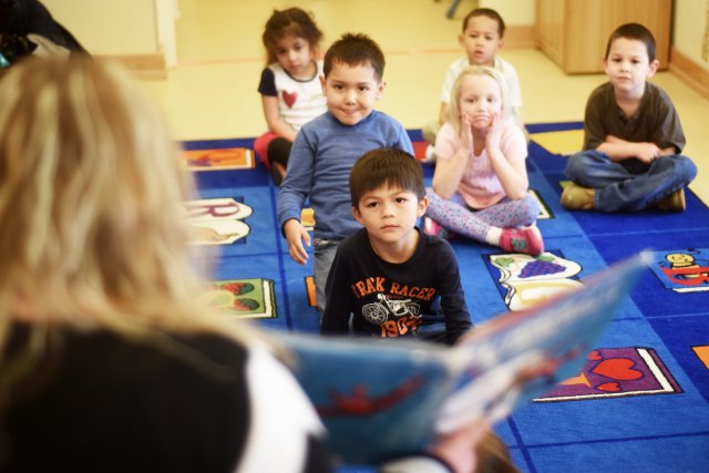 Pre-kindergarten students are read a book