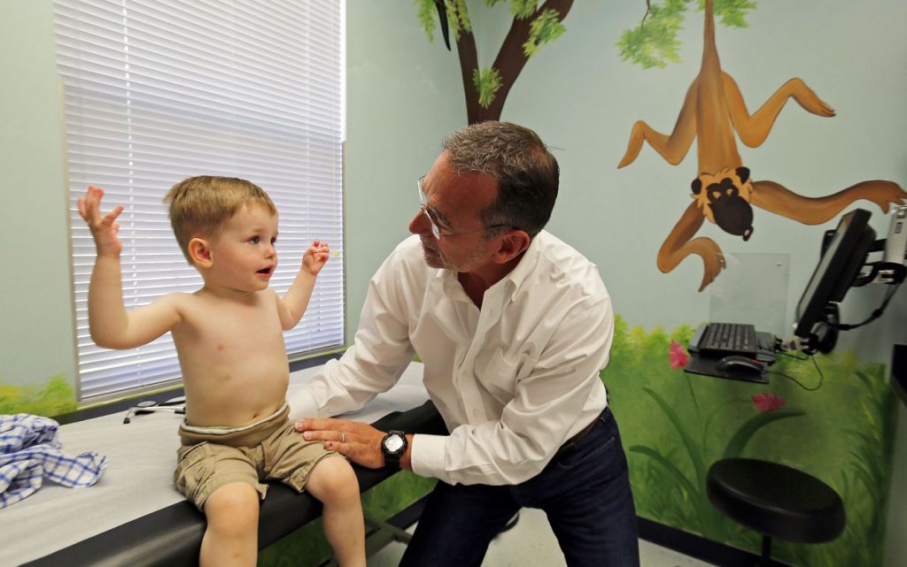 A doctor examines a 2-year-old