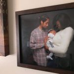 Photo hanging on a wall of Brandon Roberts (left) and Erica Jones with their son, Nasir.