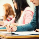 Young students taking notes in classroom