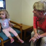 Pediatrician Brenda Holson visits with a 2-year-old patient.