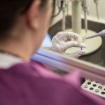 A lab technician at the Delaware Public Health Laboratory test samples for coronavirus Wednesday in Smyrna.