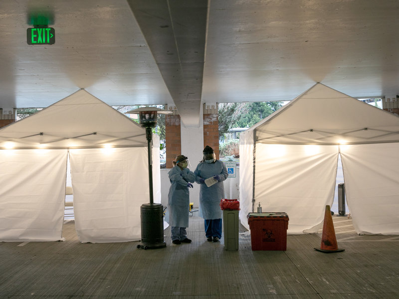 Nurses check registration lists before testing patients for coronavirus at the University of Washington Medical Center