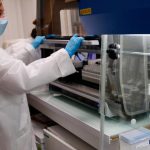 A laboratory technician prepares the machine to process the coronavirus analysis in a French medical biology laboratory.