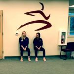 Premier Physical Therapy physical therapists Jess Lewis and Jen Atwood demonstrate a wall sit in a video posted to their Facebook page