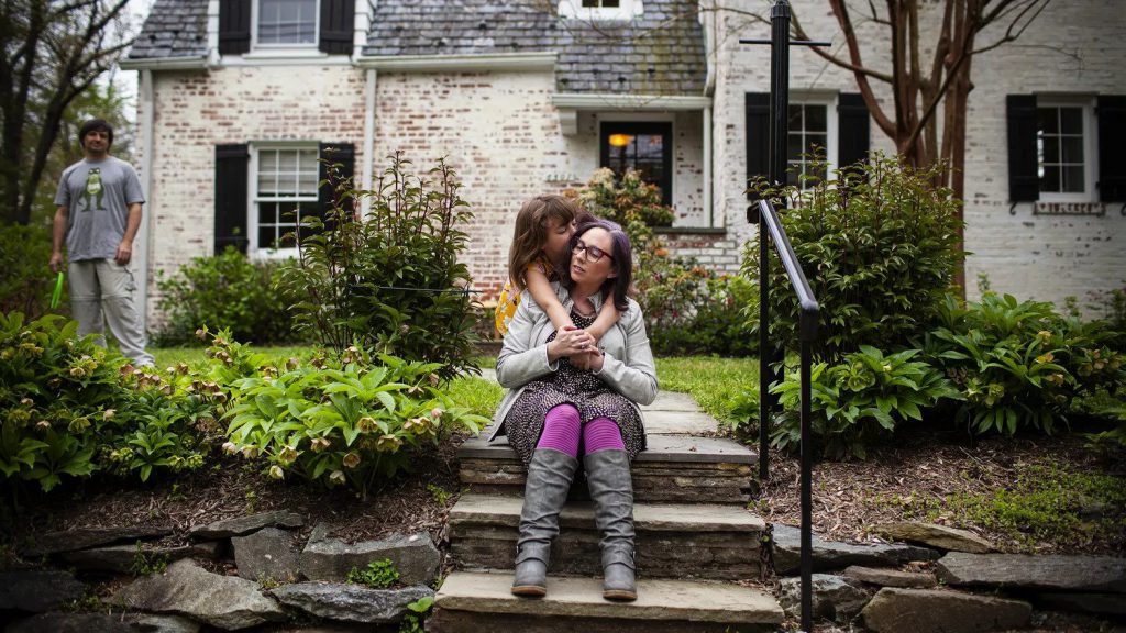 Dania Palanker with her daughter and husband in the front yard of her Washington, DC, home.