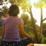 Person outdoors meditating