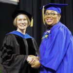 graduating student shaking hand of dean