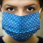 close up of woman wearing protective cloth face mask