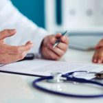 A doctor consults with a patient