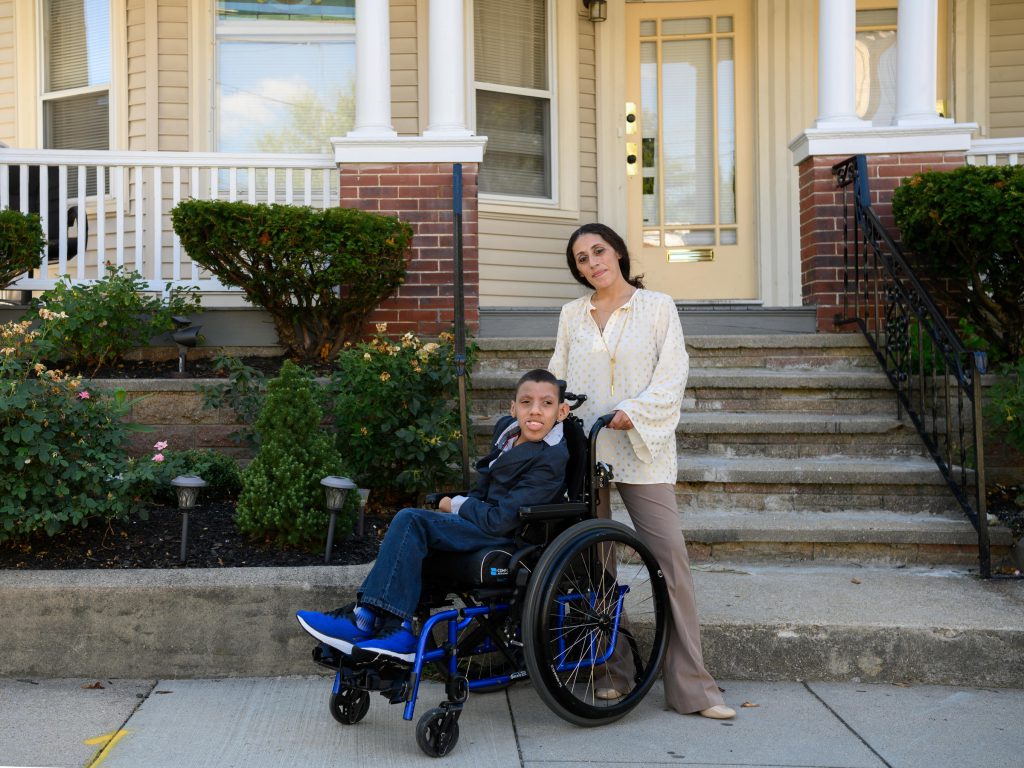 Kendra Mendoza stands slightly behind her son, Joshua, who has cerebral palsy and uses a wheelchair.