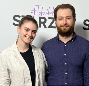 Marisa Torelli-Pedevska is a young woman with dark hair pulled up, wearing a wrinkled linen jacket and Richie Siegel is a man with wavy dark hair and beard wearing a wrinkled blue linen shirt.