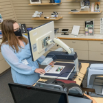 Hope Latimer demonstrates a large digital magnifier in the Kent/Sussex Assistive Technology Resource Center