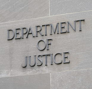 A sign marks the facade of the Robert F. Kennedy Department of Justice Building in Washington, D.C.