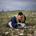A man with Down syndrome picks up trash A man with Down syndrome picks up trash for his job earning subminimum wage.