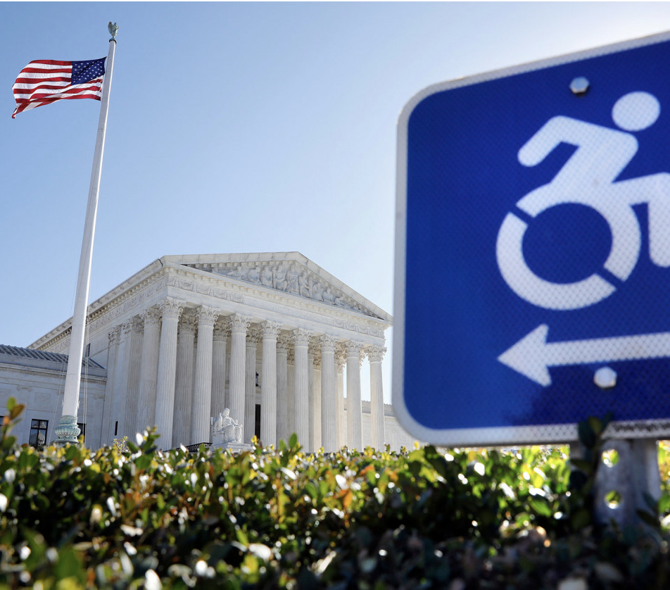 Neoclassical facade of the Supreme Court Building with its columns and pediment frieze. Accessible parking sign. U.S. flag.