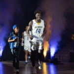 Eli Larts runs onto the Carpenter Center Court with Ebby Asamoah during Delaware basketball's Hoopla preseason basketball gathering.