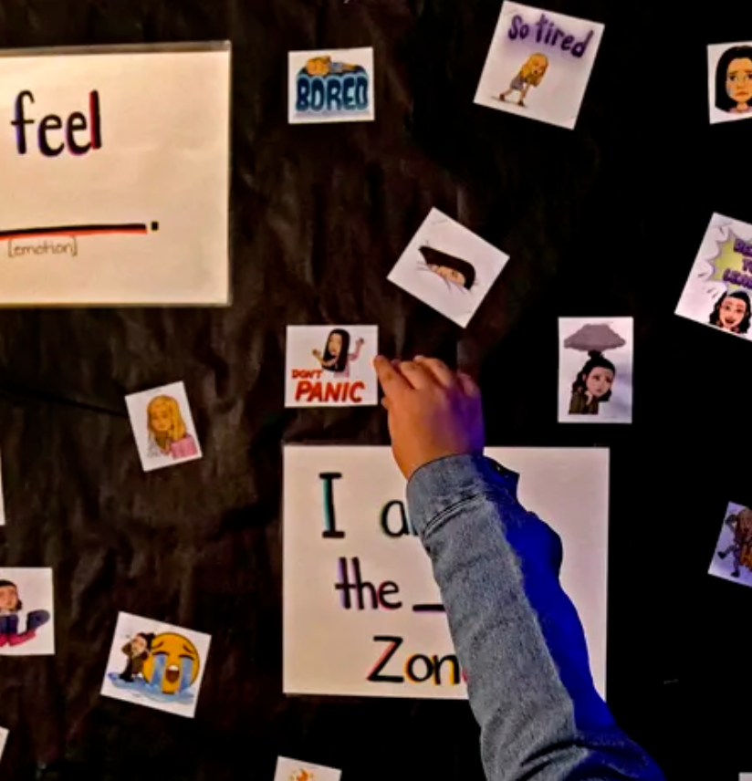 A child's hand reaches for a square of paper with a "Don't Panic" bitmoji