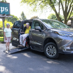 An older couple with a Toyota Siena minivan that has been converted to be accessible to wheelchairs.