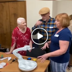 Karen Latimer demonstrates an assistive technology device to an older couple