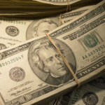 Gathered stacks of US paper currency.