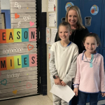 Dana Carey with young students outside of a classroom